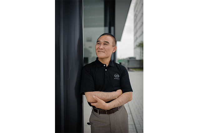 A passion for beauty and the driver Toshio Shiratori, the Product Design Director of UD Trucks, led the team who designed the striking exterior of All New Quon, and a stylish interior to match. The newly styled cabin interior is an intrinsic part of the unmatched driving experience provided at the wheel of All New Quon. What were your objectives when you designed the interior of All New Quon? The existing Quon interior was well liked and we wanted to retain what customers admired about it while improving it functionally and aesthetically. We aimed to go the extra mile on UD’s core value of “Excel on the essentials”, and truly reflect “Innovation that puts people first,” – the very idea behind the creation of All New Quon. In the design we wanted to proudly emphasize our Japanese origins, and the traditional UD hexagon that consists of six aspects: smart, caring, tough, harmonized, supportive and distinctive. UD Trucks A passion for beauty and the driver What are the highlights of the new interior? The general shape of the dashboard and the shape of each detail, the way they interact with each other, have been designed to provide a feeling of harmony. We also reworked the materials, their texture, their colors and the contrasts to create a harmonious and high quality feeling. We think this interior displays a contrast of energy and harmony typical of Japan, and perfectly matches the striking exterior design of All New Quon. Why do you have such passion for the driver? In Japan, as well as in many countries, we have a shortage of drivers. We focused on improving operability, our goal was to design a characterful interior that’s attractive, comfortable and functional, a pleasant place to be for the drivers. How was the UD gemba involved in the design? Different departments in the company including FVV (Features Verification and Validation), Cabin Engineering and Sales and Marketing were invited to view prototypes of the interior in Touch and Feel sessions, so their comments could help to perfect the end result. Th