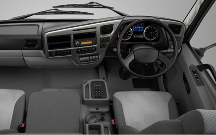 Truck interior, view of dashboard, steering wheel, and two gray seats